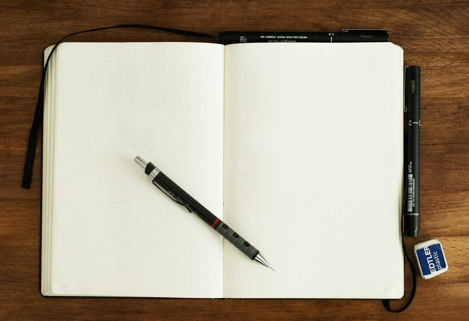 Open notebook and pen on a desk