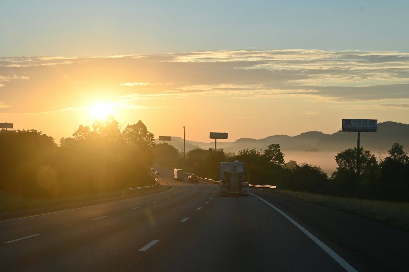 Highway at sunrise with distant mountains