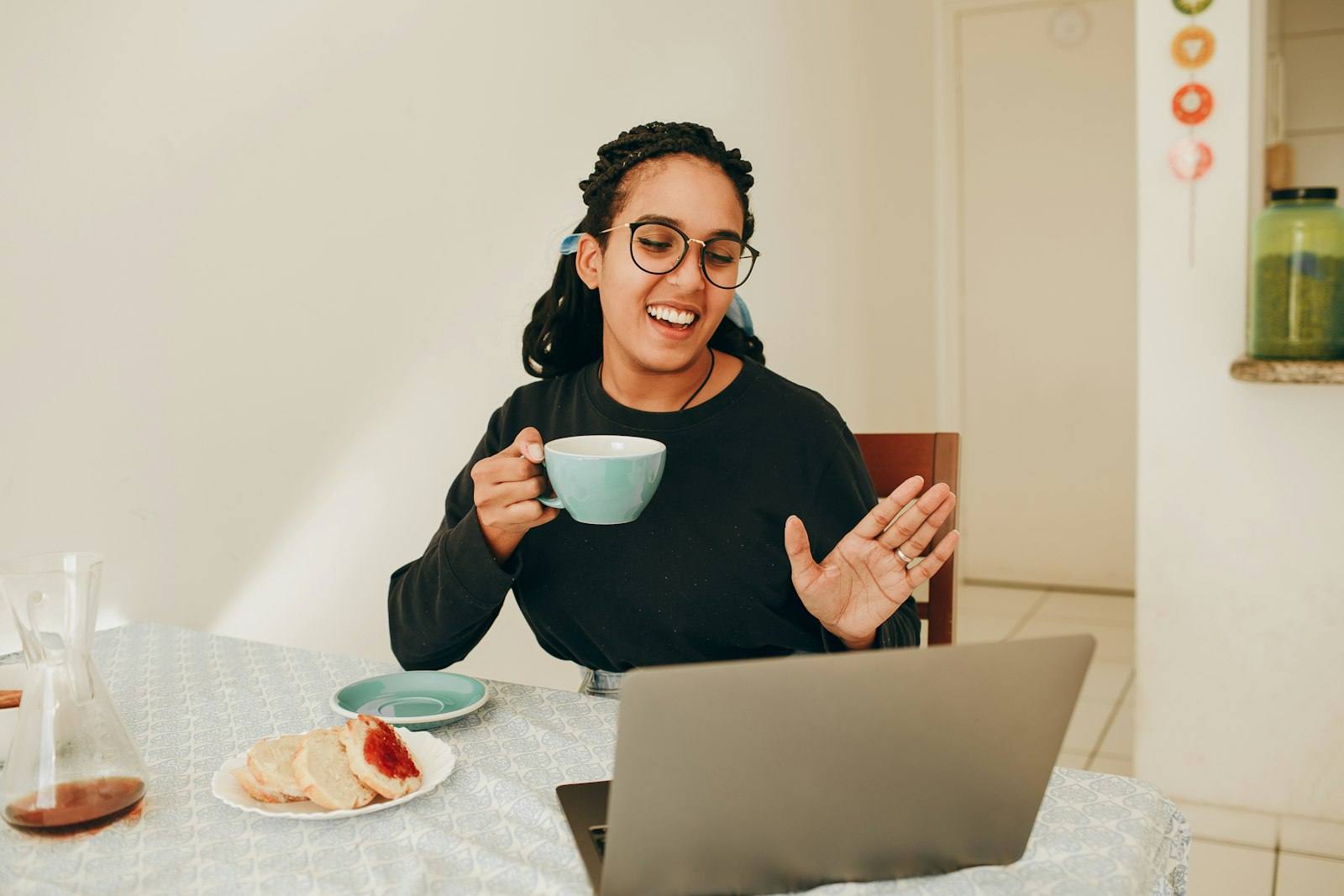 Woman smiling during an online therapy session on her laptop